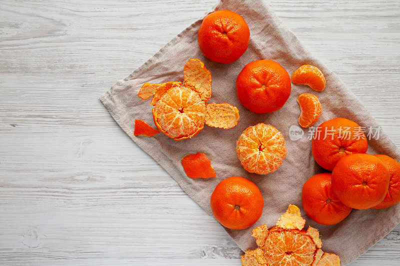 Raw Organic Mandarin Oranges on a white wooden background, top view. Flat lay, overhead, from above. Copy space.